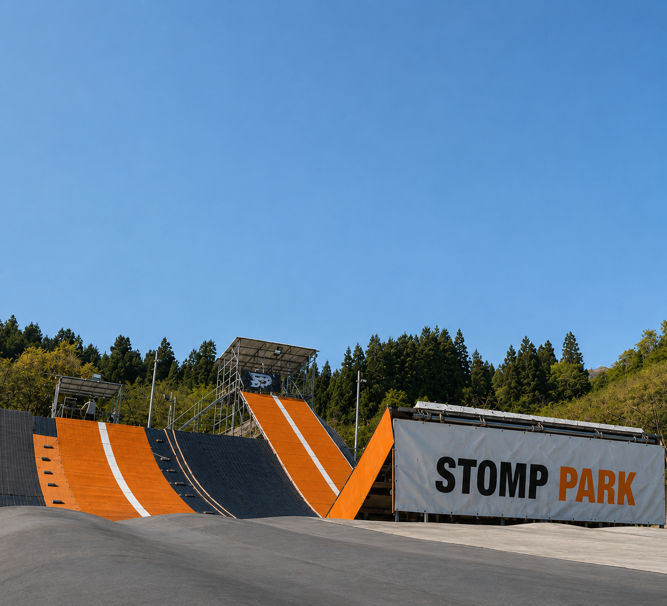 Snowboarder riding down the dryslope line at STOMP Park